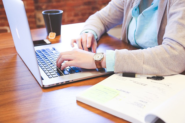 Woman working on a laptop with a cup of tea