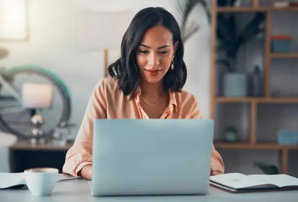 A real estate agent looking at a laptop, researching common challenges faced by new agents