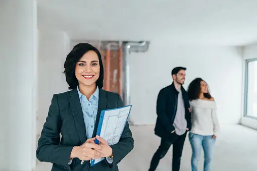 A picture of a real estate agent helping a family find a house