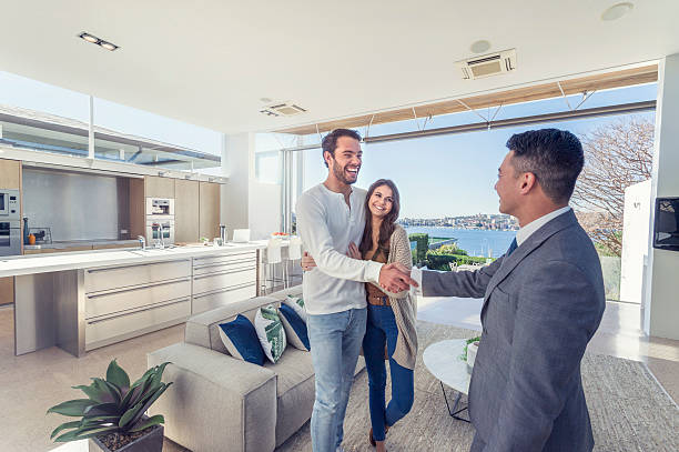 A real estate agent showing a house to a couple during a seller's market, demonstrating how to buy a house in a seller's market tips for real estate agents