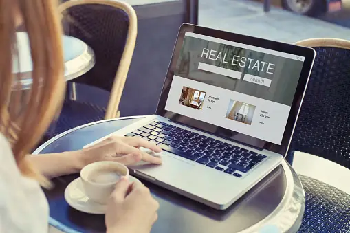 Real estate agents helping buyers with online searches and digital marketing