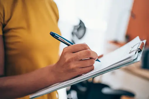 A picture of a real estate agent reviewing financial documents for effective real estate agent financial planning in regards to insurance coverage essentials.