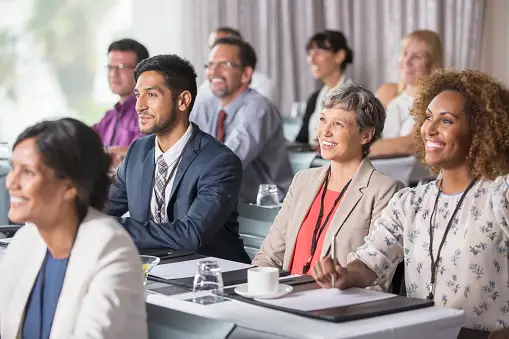 Real estate agent talking to a group of people at a networking event