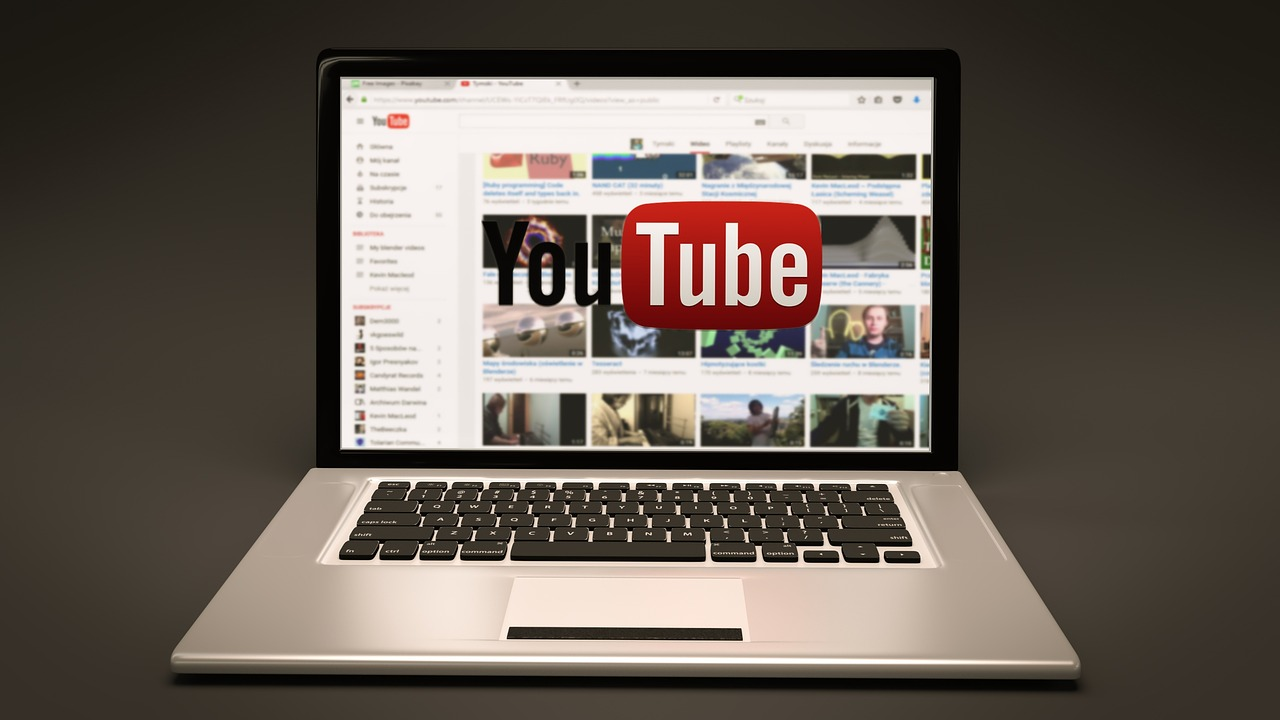 An image of a laptop screen displaying the YouTube logo, representing the importance of YouTube for real estate market updates and analysis.