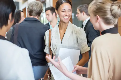 Two people talking and networking at a local business event