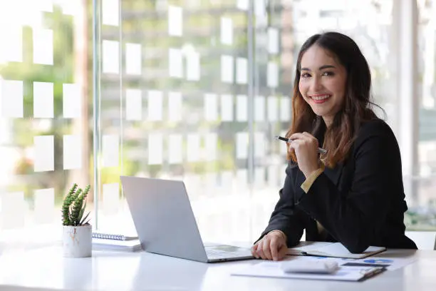 A real estate agent using a laptop to showcase multimedia in their realtor bio