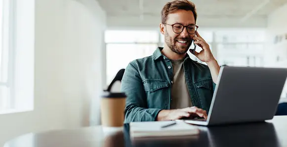 A man using a laptop to research real estate technology trends