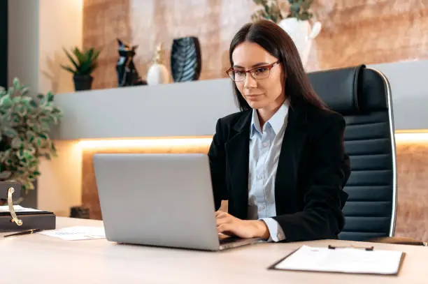 Real estate agent working on laptop in modern office