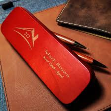 A personalized pen and engraved business card case